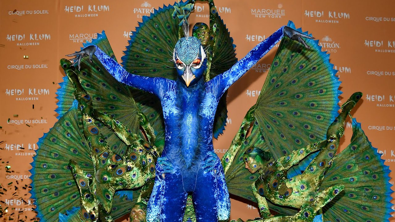 Heidi Klum arrives at her annual Halloween party dressed as a peacock